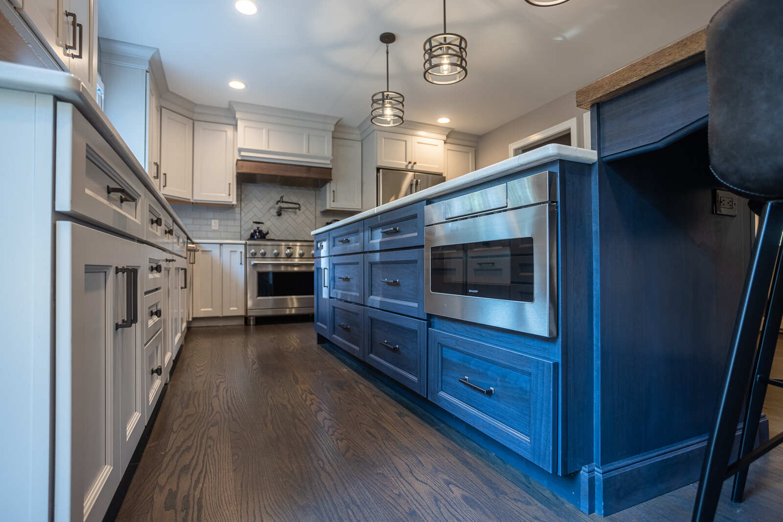 blue kitchen island cabinets with surrounding white cabinets